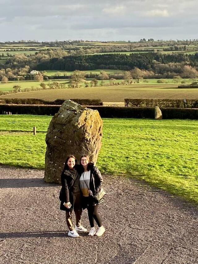 Students standing in front of a rock in Ireland 