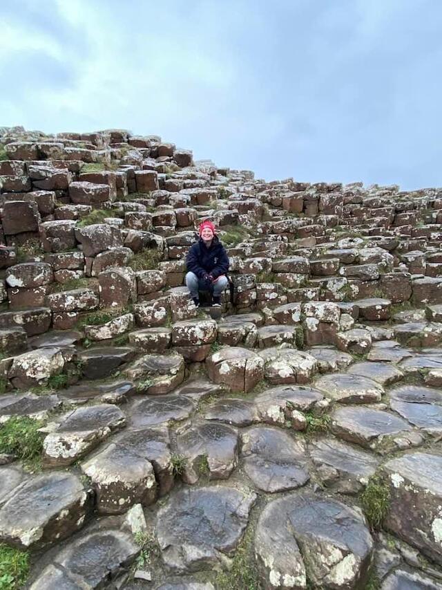 Student sitting on rocks in Ireland 
