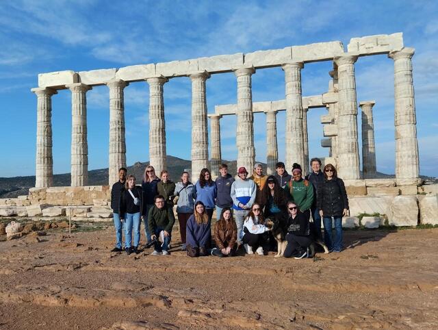 Young people in standing in front of historical architecture 