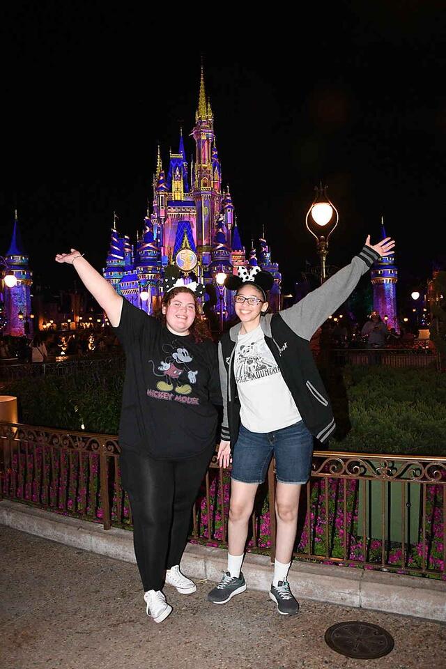 People stand in front of a castle 