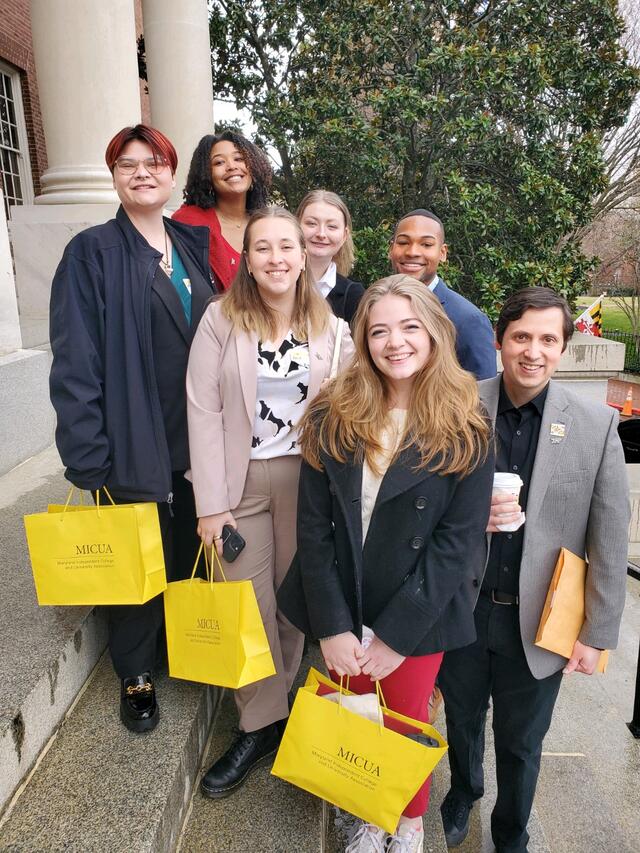 Students in professional clothing outside. 