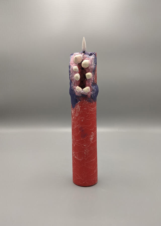 A red candle made out of clay