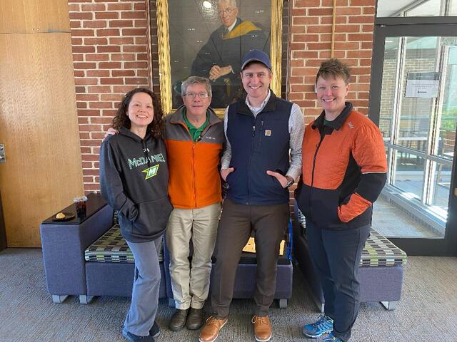 Faculty and Staff pose at Coffee Break on One Hill, One Day.