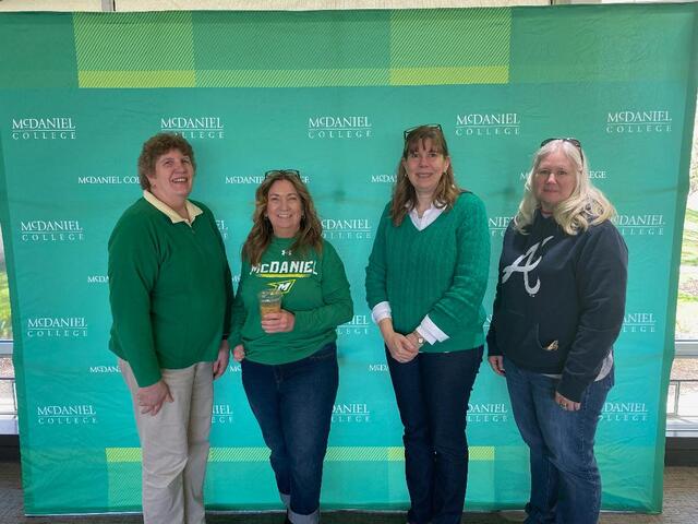 Faculty and Staff pose at Coffee Break on One Hill, One Day.