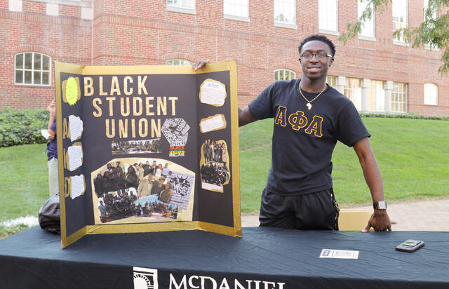 Student with Black Student Union poster 