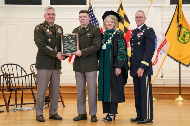 Michael Bromley receiving the Lieutenant General (R) Otto Guenther Leadership Award with President Julia Jasken, retired Major General Michael O'Guinn, and Lieutenant Colonel Seth Hartmann.