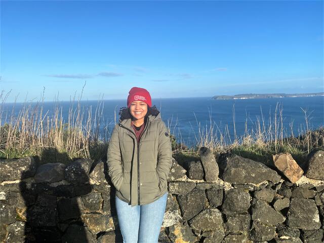 Photo of student Gabbie Gladden in Northern Ireland wearing a beanie hat that reads Queen's University Belfast.