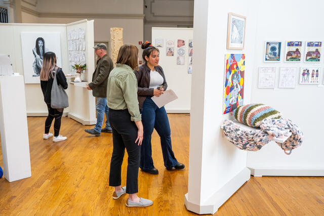 Students look at art exhibits