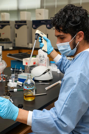 A student uses lab equipment.