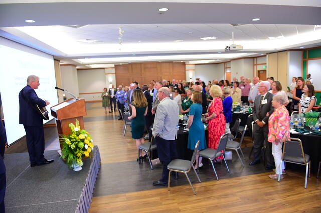 Alumni Association Awards Celebration with Steve Ports playing alma mater on guitar 