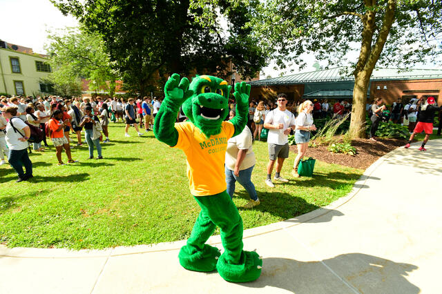 Green Terror Dancing at Orientation with students in the background