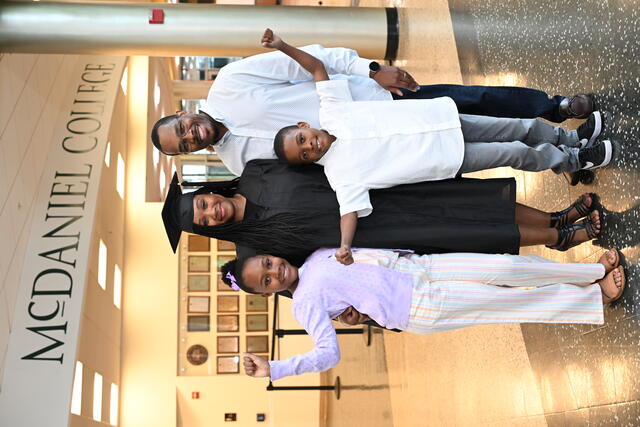 Graduate poses with family