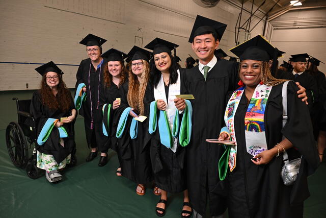 Graduates pose in regalia