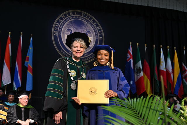 faculty member in regalia receives award