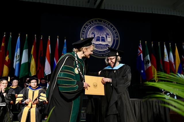 faculty member in regalia receives award