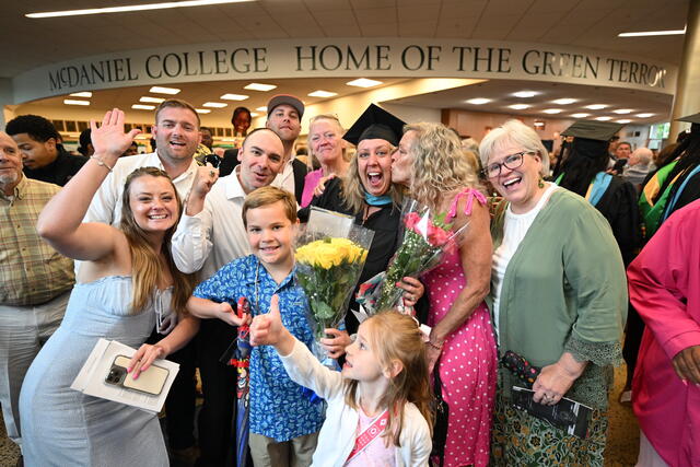 Graduate poses with family