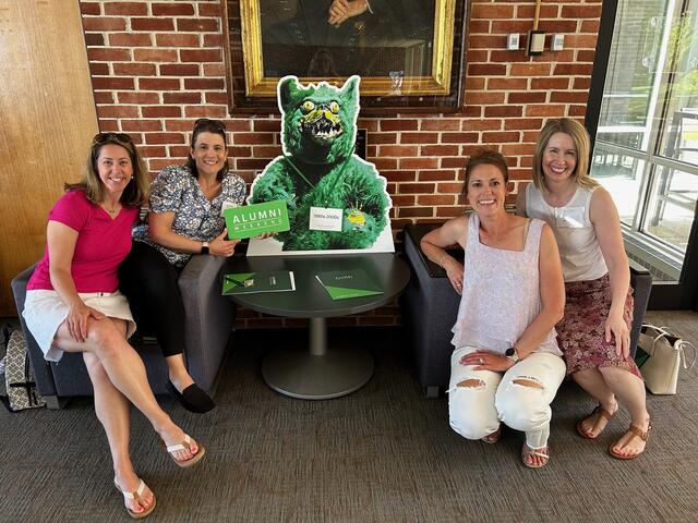 Alumni Weekend 2024 Alumni with Green Terror Cut Out