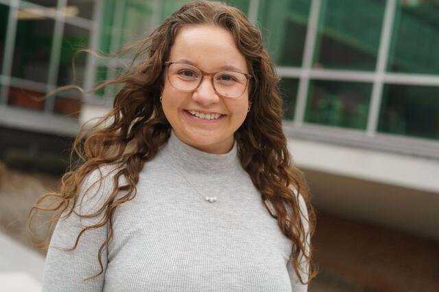 Headshot of Mackenzie McCarter outside the student center wearing a grey shirt.