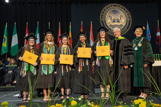 Recipients of The Argonaut Award pose on stage with Bruce H. Preston '75, chair of the Board of Trustees, and President Julia Jasken.