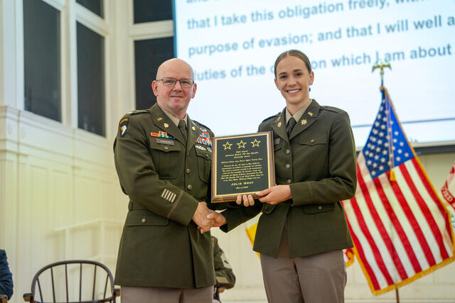 Student Jolie Gray poses with a plaque for the Otto Guenther Leadership Award.