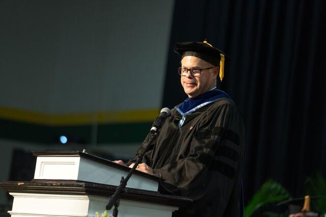 Simeon Schlossberg at the podium at Commencement.