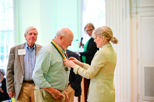 Members of the Class of 1975 receive their 50th Reunion medallions from President Julia Jasken.
