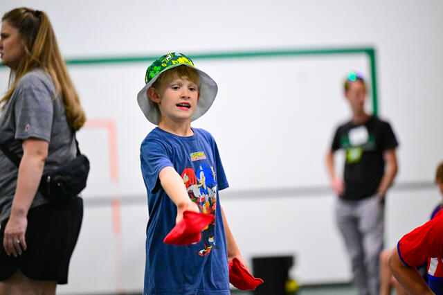 A future Green Terror plays cornhole at the lawn party.