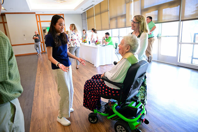 Marion Geyer '50 visits with fellow Trumpeter Patty Punchasutthi '26.