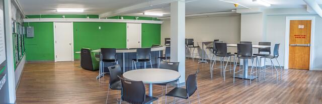 panoramic view of large space with desks and tables