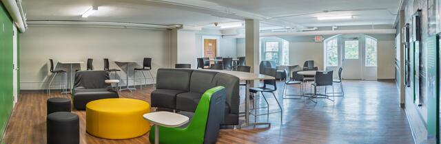 Panoramic view of a large space with tables and chairs