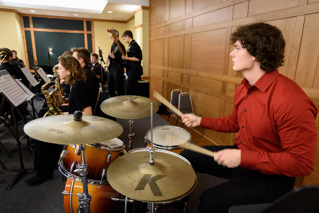 student plays the drums