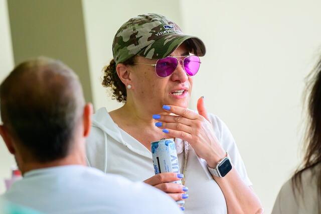 A guest enjoys a beverage at the Green & Gold happy hour.