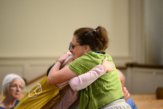 Alums embrace at the Memorial Bell Ringing. 