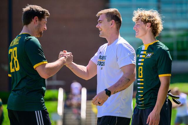 Men's Soccer alums greet each other