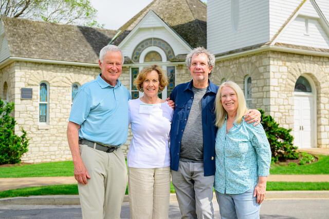 Two couples in front of Little Baker Chapel. 