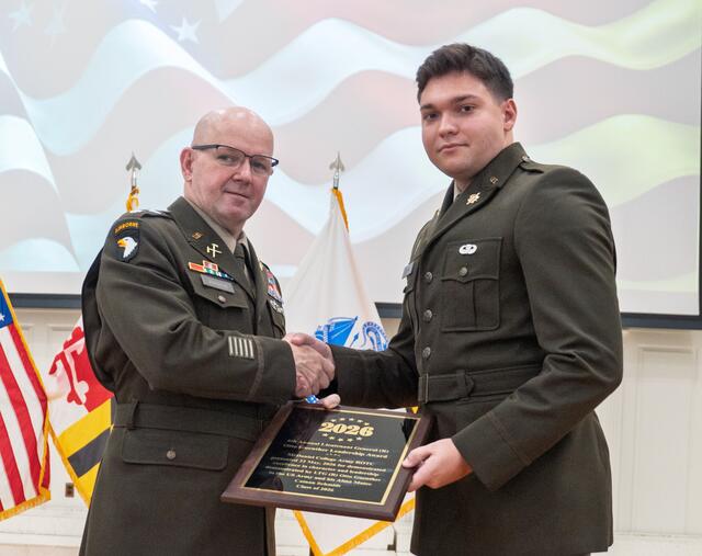 Cainan Schmidt receives the a plaque.