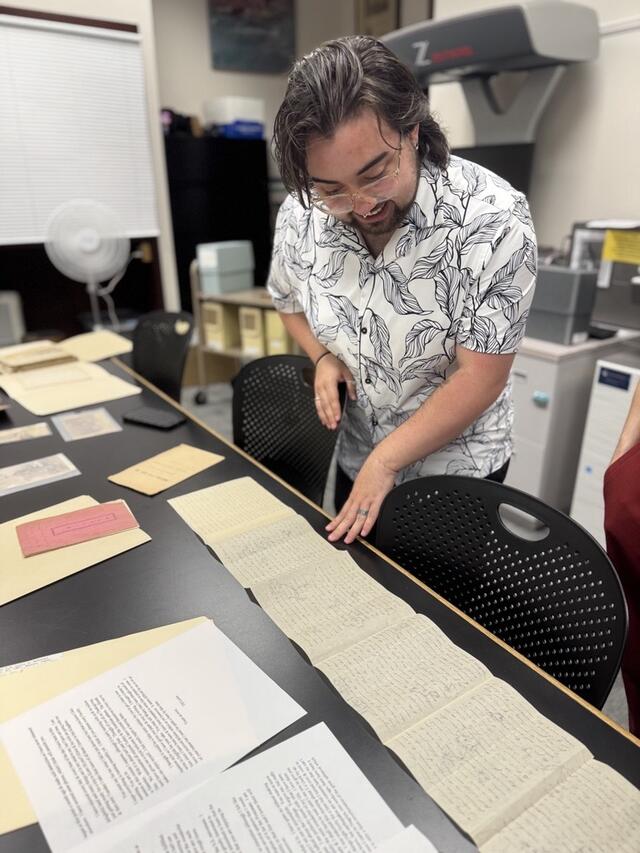 Casper Speno studies the long letter written by T.H. Lewis.