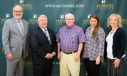 Carroll County Food Sunday executive director Ed Leister (center, left) and administrator Dennis Fahey with McDaniel President Roger Casey (left) and McDaniel Center for Experience and Opportunity associate director Kristen Maddock and director Connie Sgarlata