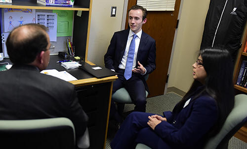 Senior Accounting-Economics and Business Administration major Michael Nepini explains his career goals to Gross Mendelsohn representatives Ed Thompson and Jocelyn Diaz â18. 