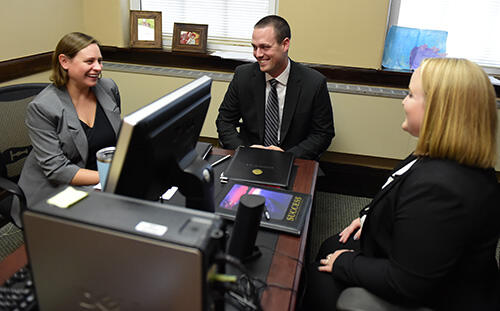RSM representatives Julia Flannery â04 and Mike Bucci â15 talk with sophomore Accounting-Economics and Business Administration major Jaidyn Nicely of Sparrows Point, Md.