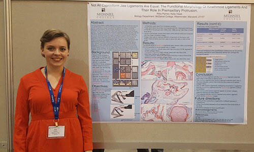 Riley Palmer in front of her poster.