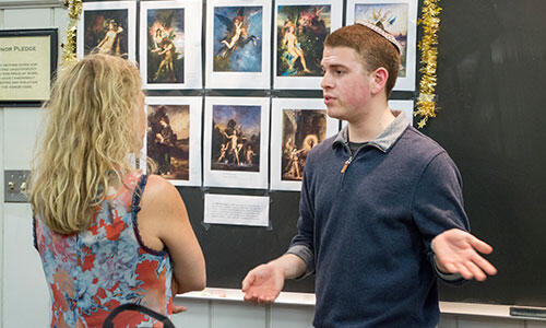 Samuel Blank, a junior French major from Finksburg, Md., discusses Salon de la Rose + Croix during the Paris Exposition in the Art in Paris Reacting to the Past game.