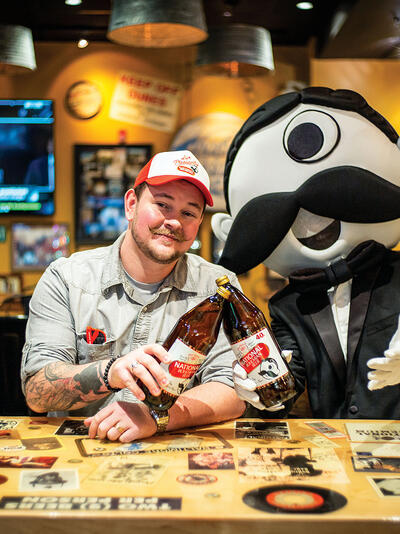 Christopher Molloy, National Bohemian brand manager, and Boh, the mascot