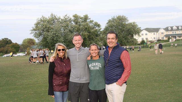 Christie Pearce Rampone and Steven Hegna Group on field.