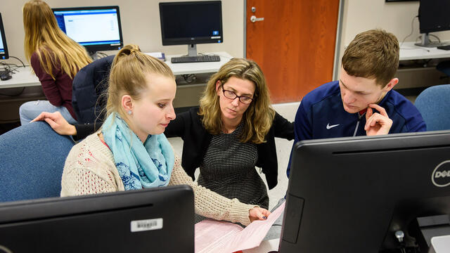 Kerry Duvall, assistant professor of accounting, assists McDaniel students during a Volunteer Income Tax Assistance (VITA) session.