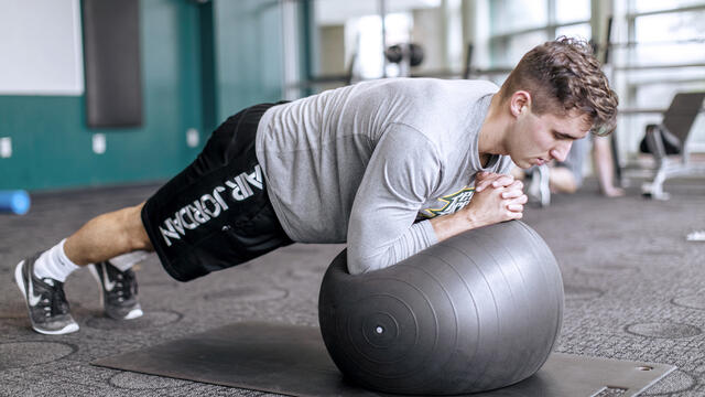 Student using workout equipment in Merritt Fitness.