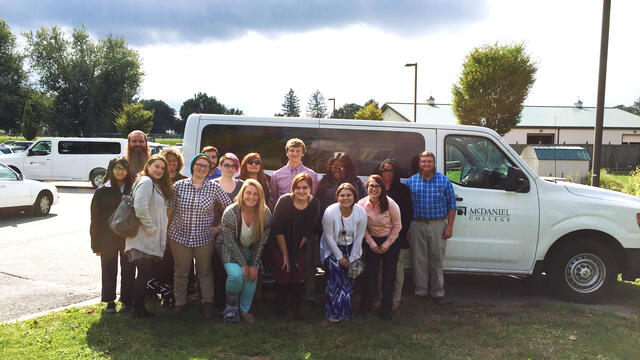 Religion Prison Student Group standing in front of bus.