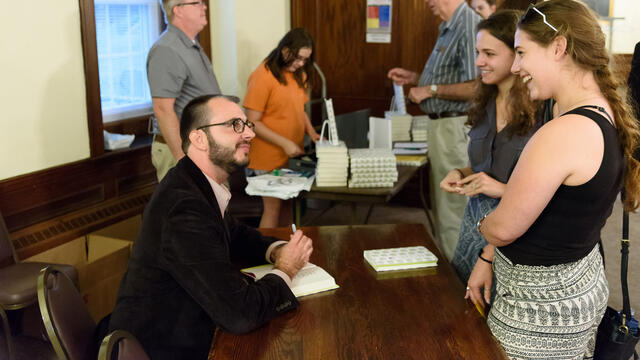 Jared Reck signs copies of his new book, “A Short History of the Girl Next Door” in McDaniel Lounge.