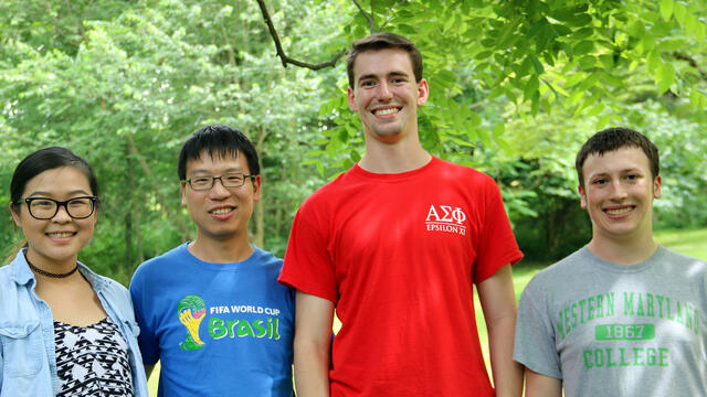 Biology professor Cheng Huang (second from left) with his research students (l-r), Molecular Biology majors Fangluo Chen, Harrison Curnutte and Garrett Gregoire.