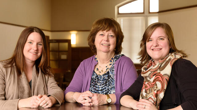 Alumnae poets Bothe Meadows Mangan Mercer sitting at table.